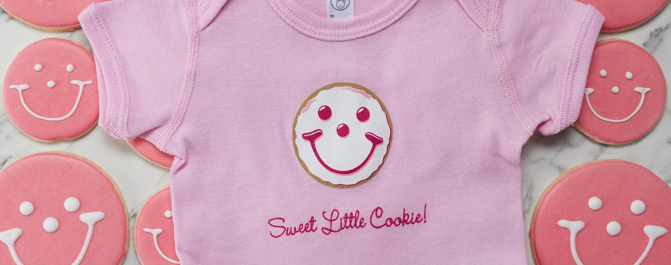 sweet little cookie baby girl onesie with baby pink smiley cookies