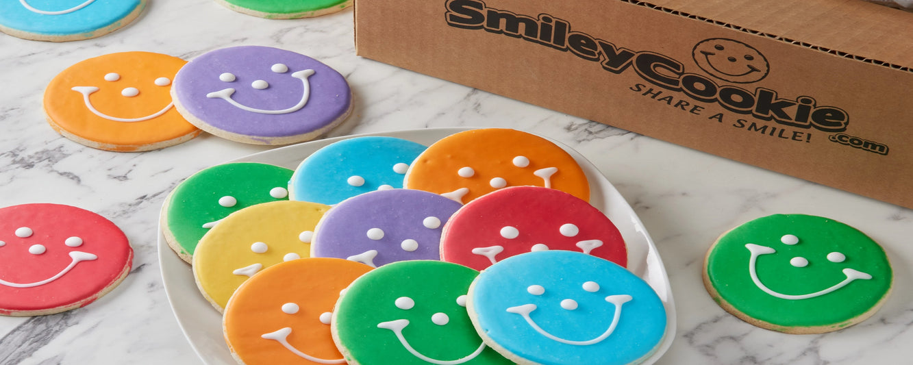 a plate full of fall smiley cookies in yellow, orange and red