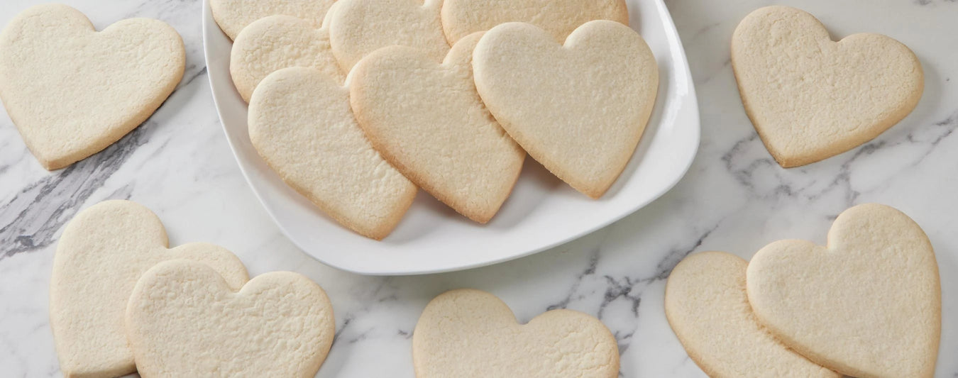 decorate your own smiley cookies with our diy kits, this one features heart shaped cookies with pink white and red icing packs