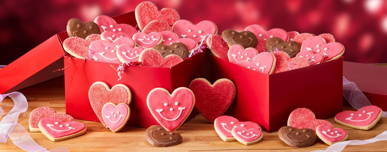 A collection of heart cookies and chocolates in a red box for valentine's day