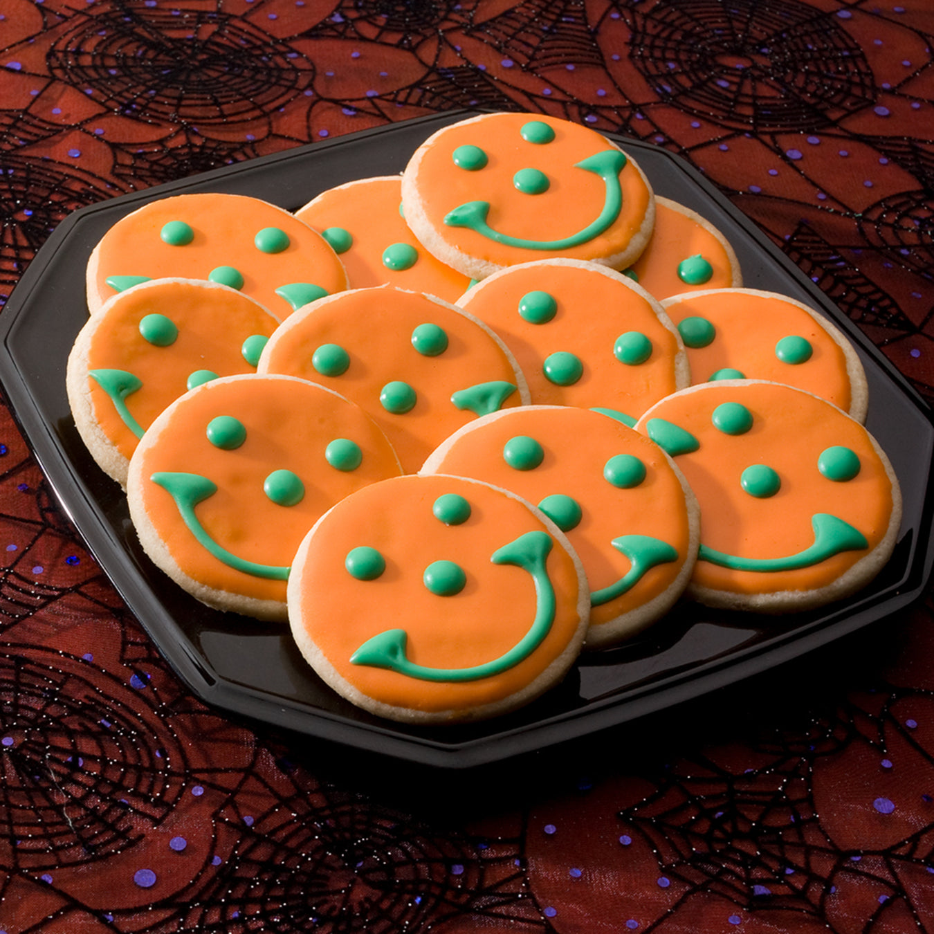 create your own smiley face cookies in colors of orange and green for halloween